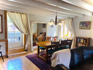 a living room with a table and a dining room at La Miette in La Celle-sous-Gouzon