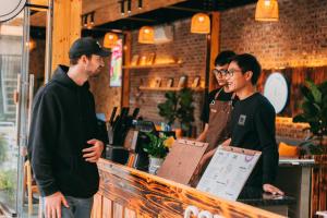 three men standing at a counter in a restaurant at Tam Coc Lavender Homestay -Authentic Ninh Binh Experiences in Ninh Binh +144 photos
