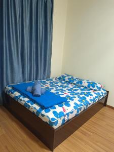 a bed with a teddy bear on top of it at Seaview Emerald Sandakan in Sandakan