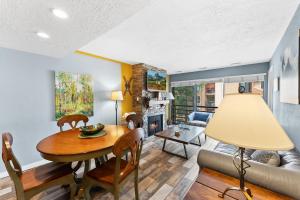 a living room with a table and a couch at Main St Wanderlust, Resort Bliss and Nearby Dining Delights in Park City