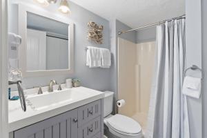 a bathroom with a sink and a toilet and a mirror at Main St Wanderlust, Resort Bliss and Nearby Dining Delights in Park City +12 photos