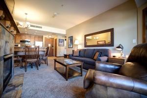 a living room with a couch and a table at Ski IN Out, Perfect Location King Bed at Sundial Lodge w Hot Tub and Pool! in Park City