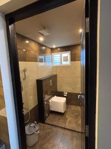 a bathroom with a sink and a toilet at Cicadas Nature Resort - A Frame cottages in Wayanad +94 photos
