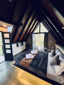 a bedroom with a large bed in a room at Cicadas Nature Resort - A Frame cottages in Wayanad