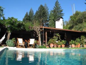a house with a swimming pool in front of a house at Casa Dos Canais, River Cottage in Marco de Canavezes