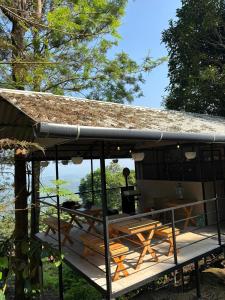 a cabin with a table and chairs on a deck at Cicadas Nature Resort - A Frame cottages in Wayanad