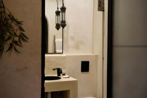 a small bathroom with a sink and a sink at Riad Solange in Marrakesh +32 photos
