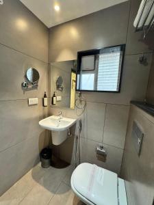 a small bathroom with a sink and a toilet at HOTEL TOUCHWOOD in Visakhapatnam