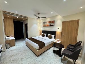 a hotel room with a large bed and a bathroom at HOTEL TOUCHWOOD in Visakhapatnam