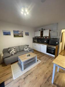 a living room with a couch and a table at Ferienwohnung Mittendrin - Chiemgau Karte in Inzell