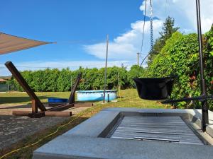 a patio with a pool and a swing at Andreas Apartman in Keszthely