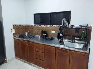 a kitchen with a sink and a counter top at San Antonio in El Peñol