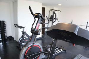 a row of exercise bikes in a gym at Departamentos Wonderlust Dorotea in Puerto Natales