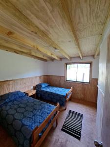 Un pat sau paturi într-o cameră la Refugio Tringlo