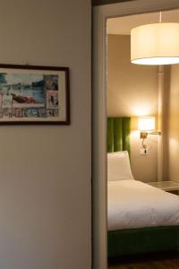 Postel nebo postele na pokoji v ubytování Hotel Suisse