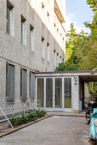 a large brick building with a large glass door at Teatro Romano Suites - Francesca in Trieste