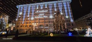 a large building with a christmas tree in front of it at Ultracentral Residence 6 in Ploieşti