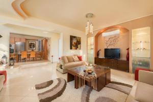 a living room with a couch and a table at Natura House in Ialyssos