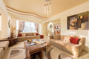 a living room with a couch and a table at Natura House in Ialysos