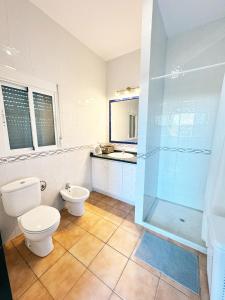 a bathroom with a toilet and a shower at Can Pines in Paradas
