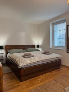 a bedroom with a bed with two pillows on it at Chalupa DEMÄNOVÁ in Liptovský Mikuláš