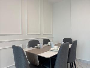 a dining room with a table and chairs at Alfa Bangsar By Fwd Host in Kuala Lumpur