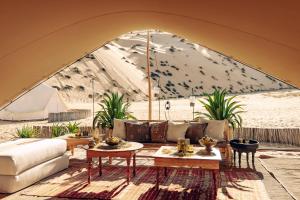 a living room with a couch and a table at Magic Camp Wahiba Sands in Bidiyah