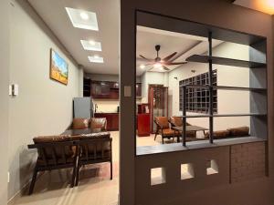 a living room with a glass door leading to a dining room at Triple Hostel in Ho Chi Minh City