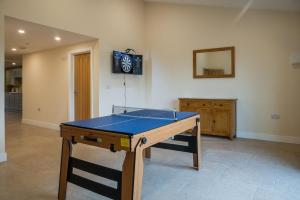 a room with a ping pong table and a mirror at Bears Court Barn 8 in Cheltenham