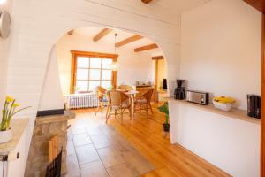 a kitchen and living room with a table and chairs at Casa Foresta in Bad Lauterberg