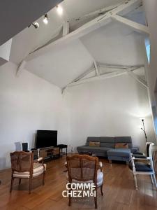 a living room with a couch and a tv at Le Chatelier in Louvemont +29 photos