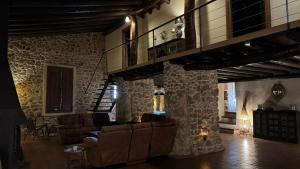 a living room with couches and a fire place at Finca El Corchito Aracena in Aracena