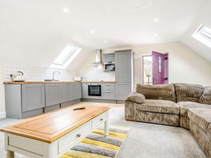 a living room with a couch and a table at Bears Court The Flat in Cheltenham +16 photos