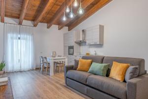 a living room with a couch and a kitchen at Agriturismo Santa Rosa in Lubriano
