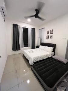 a bedroom with a bed and a ceiling fan at FA Homestay KLIA in Nilai