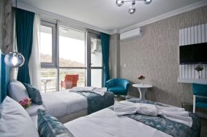 Postel nebo postele na pokoji v ubytování Hill Life Hotel