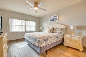 a bedroom with a bed and a ceiling fan at Direct Beach Access and View Satellite Beach Condo! in Satellite Beach