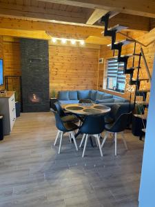 a living room with a table and chairs and a couch at Domek w Budzie Ruskiej in Buda Ruska