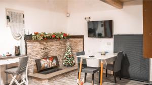 a living room with a christmas tree next to a fireplace at DIMORA HELIANTHUS in Salandra