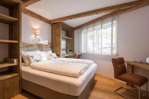 a bedroom with a large bed and a window at Luxus Ferienwohnung Almhütte in Brixen im Thale