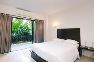 Voodi või voodid majutusasutuse Wilacha Chiang Rai toas