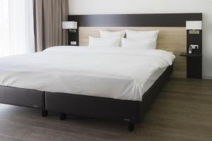 Postel nebo postele na pokoji v ubytování Taste Style Hotel Bären Auggen