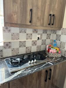 a kitchen counter with a stove top in a kitchen at 2 Bedroom Spacious Apartment in Islamabad in Islamabad