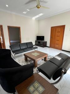 a living room with couches and a coffee table at 2 Bedroom Spacious Apartment in Islamabad in Islamabad +8 photos