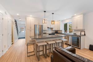 a kitchen with a large island with bar stools at Borealis by Rendez-Vous Mont-Tremblant in Mont-Tremblant