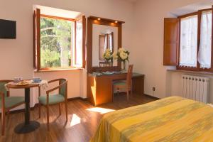 a bedroom with a bed and a table and a desk at Affittacamere Villa Gigli in Sirolo +75 photos
