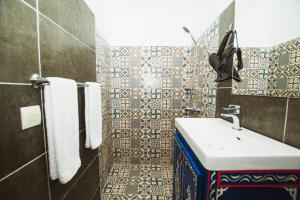 a bathroom with a sink and a mirror at Riad Dar Kella in Marrakech +105 photos