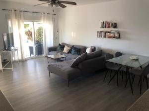 a living room with a couch and a table at Villa Tranquilla in Estepona