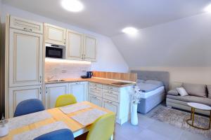 a kitchen with a table and chairs and a couch at Apartmán Relax Pernink in Pernink