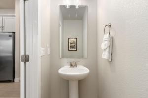 a bathroom with a white sink and a mirror at NOCO Retreat with King Beds, Fireplace, Scenic Trails in Loveland